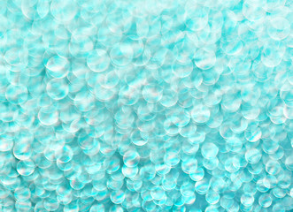 Turquoise background of shining drops of water