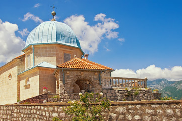 Obraz premium Religious architecture. Ancient Church of Our Lady of the Rocks ( Gospa od Skrpjela ) on sunny summer day. Montenegro