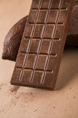 Cocoa beans and chocolate on natural paper background