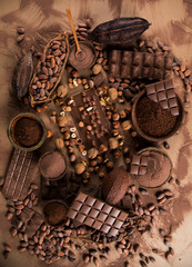 Cocoa beans and chocolate on natural paper background