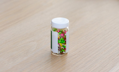 Multicolored pills in a vial