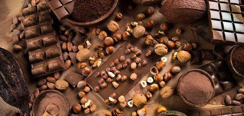 Cocoa beans and chocolate on natural paper background