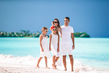Young family of four on vacation have fun