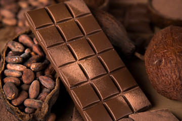 Cocoa beans and chocolate on natural paper background