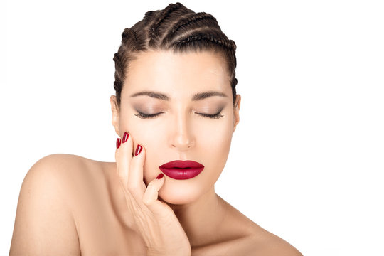 Beautiful braided hair model with mat red lips and nails. Beauty makeup and cosmetics