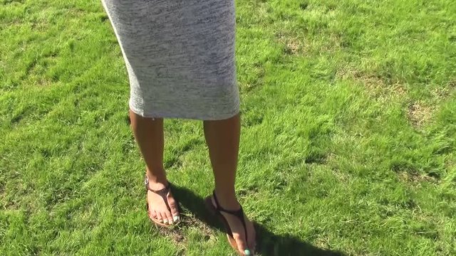 Young Woman Stomping Divots On Polo Field