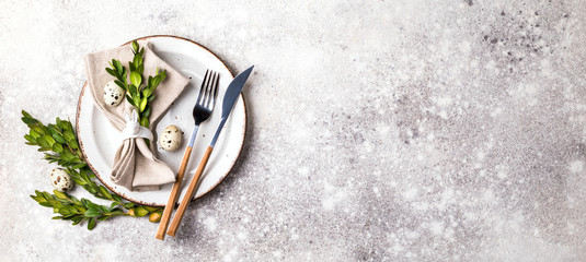 Easter table setting  on on gray background. Holiday decoration.Happy Easter concept. Copy space for Text.