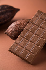 Cocoa beans and chocolate on natural paper background