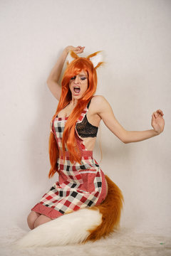 sexual hot slim redhead anime girl posing as little fox with furry ears and fluffy long tail alone on white background