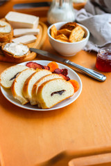 cornflakes, coffee, cottage cheese, bread, butter, eggs, jam and other ingredients for breakfast on a dark background. Top view with copy space