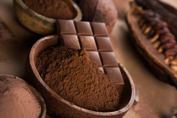Cocoa beans and chocolate on natural paper background