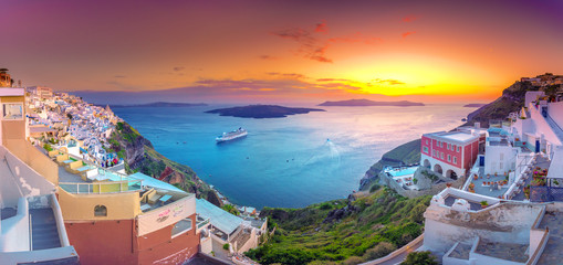 Amazing evening view of Fira, caldera, volcano of Santorini, Greece with cruise ships at sunset. Cloudy dramatic sky. - obrazy, fototapety, plakaty