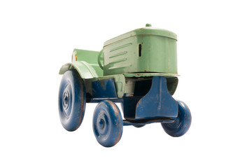Vintage toy green metal tractor with blue wheels on white isolated background