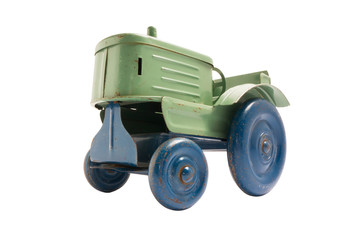 Vintage toy green metal tractor with blue wheels on white isolated background
