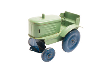 Vintage toy green metal tractor with blue wheels on white isolated background