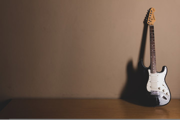 electric guitar in front of a vintage wall