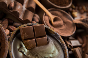 Cocoa beans and chocolate on natural paper background