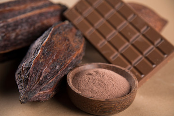 Cocoa beans and chocolate on natural paper background