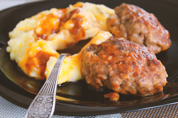 Meat patties and mashed potatoes in a plate. Close-up. Background.