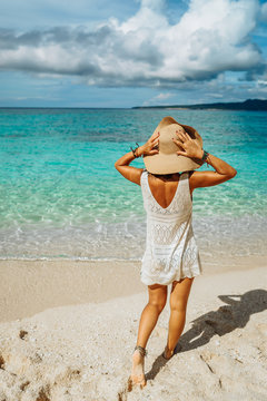 Girl on a tropical beach with hat. Philippines, Boracay