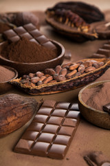 Cocoa beans and chocolate on natural paper background