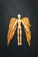 Wooden angel on black background