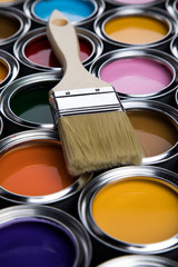 Metal tin cans with color paint and paintbrush