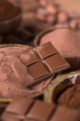 Cocoa beans and chocolate on natural paper background