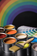 Metal tin cans with color paint and paintbrush
