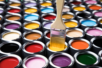 Tin cans with paint and brushes