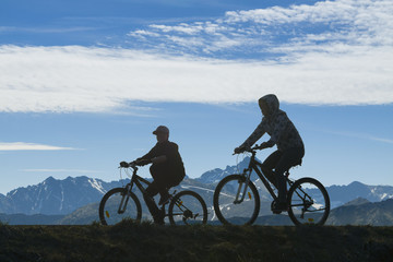 Obraz na płótnie Canvas Two Cyclists Against Mountain Landscape