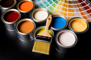 Metal tin cans with color paint and paintbrush