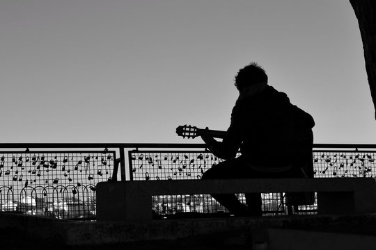 Musician playing the guitar on a viewpoint in Lisbon