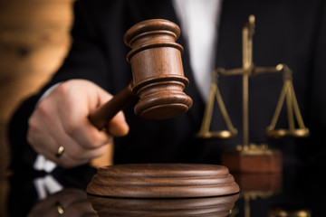 Judge, male judge in a courtroom striking the gavel