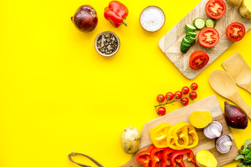 Fresh organic vegetables for healthy food cooking on yellow background top view mock up