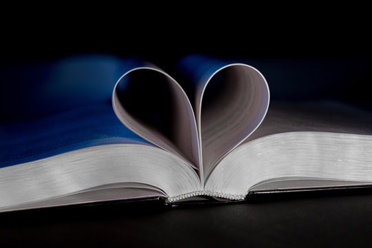Close-up. Pages of book shaped with heart symbolizing the love of education, knowledge, and reading books
