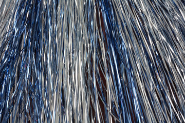 Abstract festive celebration blue and silver streamer metal tinsel background