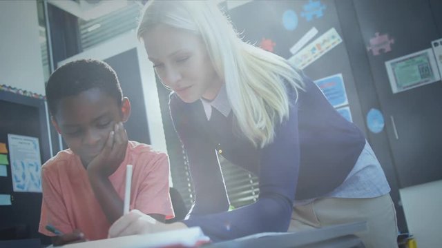 Teacher explaining exercise to schoolboy