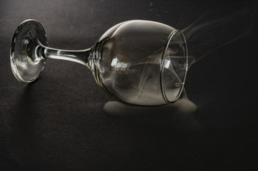 wine glass with white smoke on black background