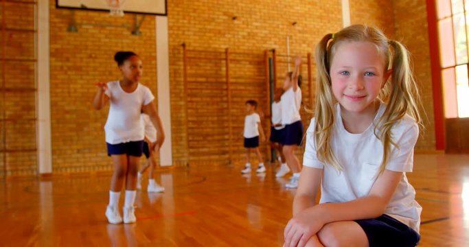 Schoolgirl relaxing in basketball court at school 4k