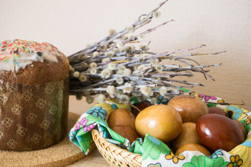 Interior decoration with willow, Easter cake and painted eggs