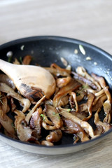 Fried mushrooms with olive oil and herbs. Selective focus.