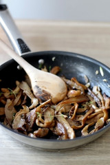 Fried mushrooms with olive oil and herbs. Selective focus.