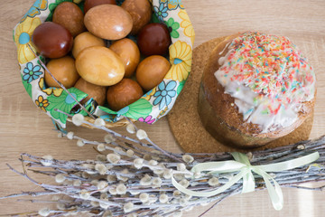 Interior decoration with willow, Easter cake and painted eggs