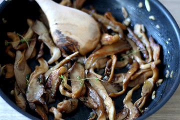 Fried mushrooms with olive oil and herbs. Selective focus.
