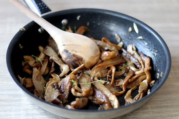 Fried mushrooms with olive oil and herbs. Selective focus.