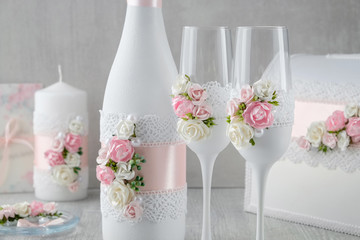 Wedding set: bottle of champagne, glasses, candle, wedding album, invitations.