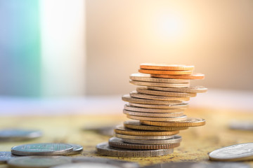 Global, Business, Risk, Money and saving concept. Close up of unstable stack of coins on world map.