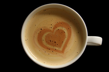 Coffee cup with a heart in the foam concept for love and goodness