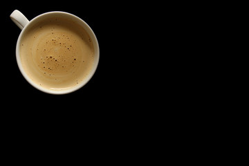 View from above. coffee with froth in a cup on a black background; shot with space for text